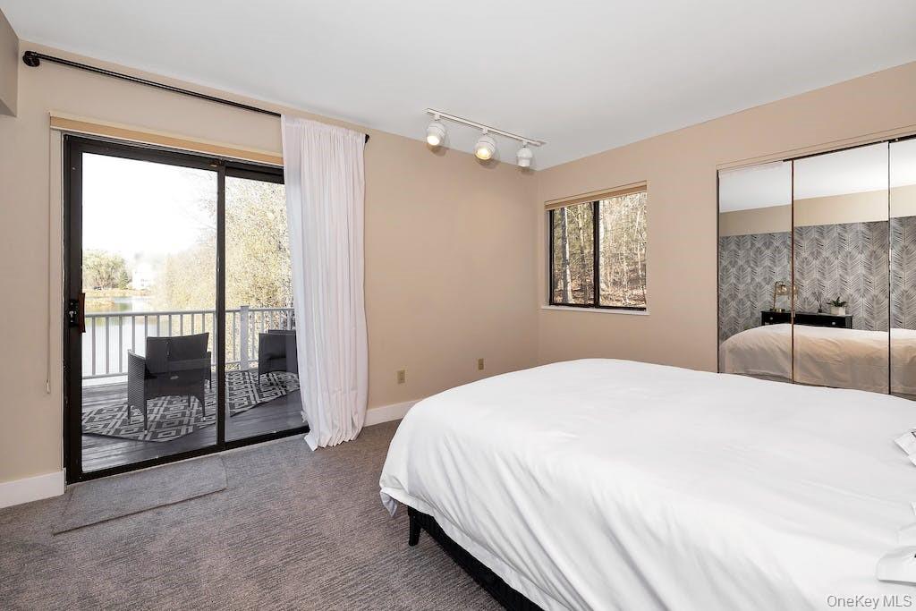 103 Rambling Brook Road Chappaqua, NY 10514 - Photo 17 of 33 a bedroom with a large bed and a large window