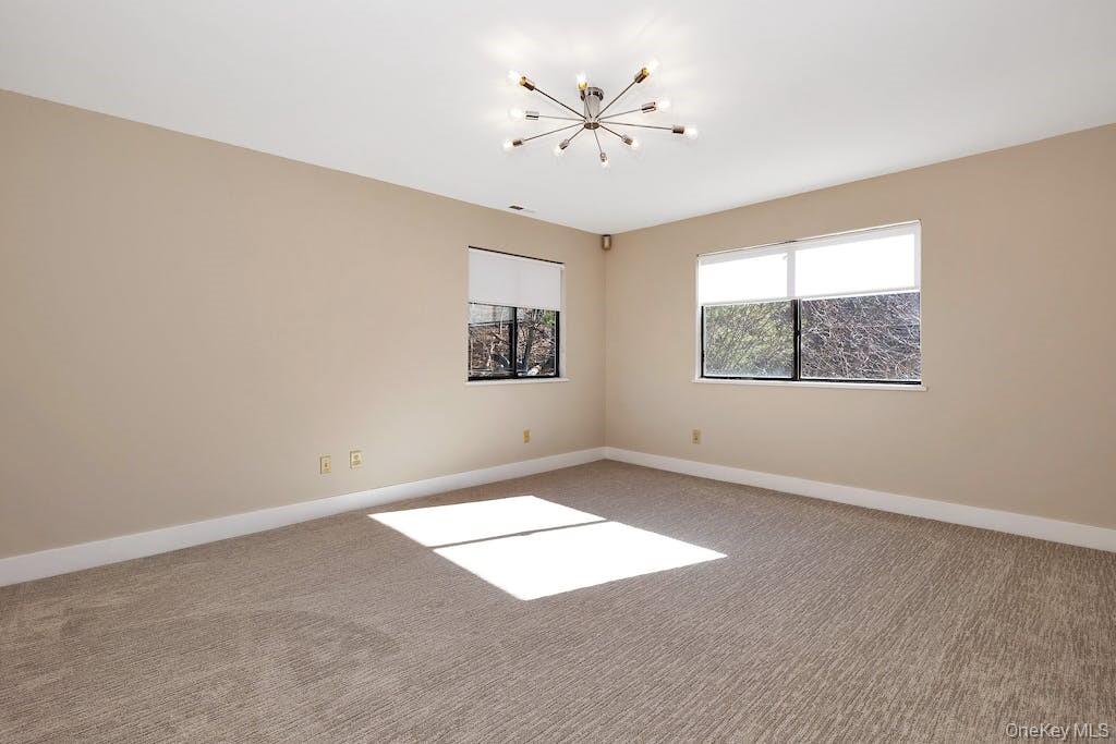 103 Rambling Brook Road Chappaqua, NY 10514 - Photo 21 of 33 an empty room with windows and fan