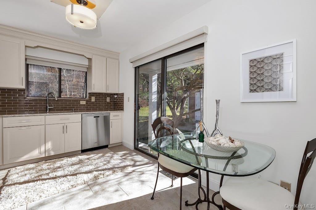 103 Rambling Brook Road Chappaqua, NY 10514 - Photo 6 of 33 a kitchen with a sink cabinets and dining table