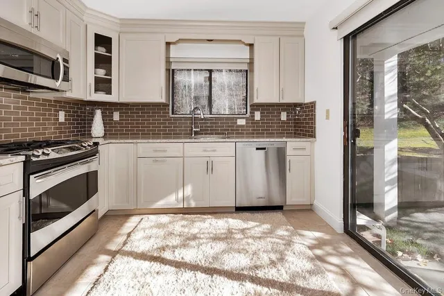 a room with lots of windows and glass door