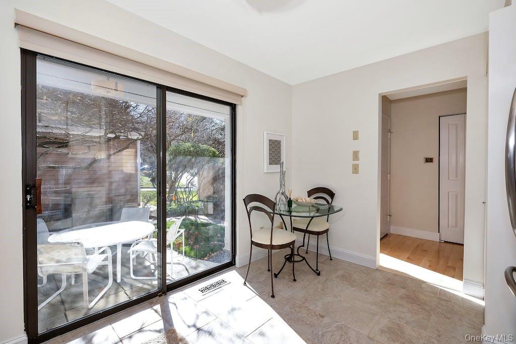 103 Rambling Brook Road Chappaqua, NY 10514 - Photo 10 of 33 a room with lots of windows and glass door