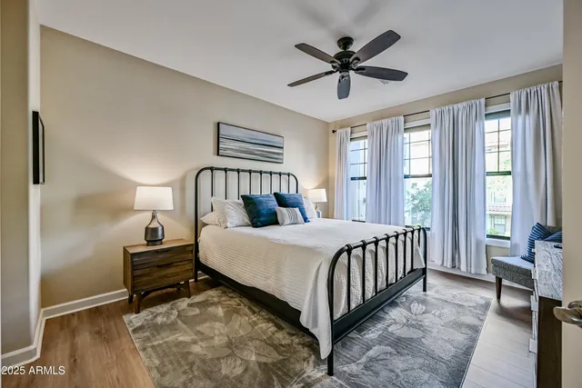 a bedroom with a bed a flat screen tv and a couch