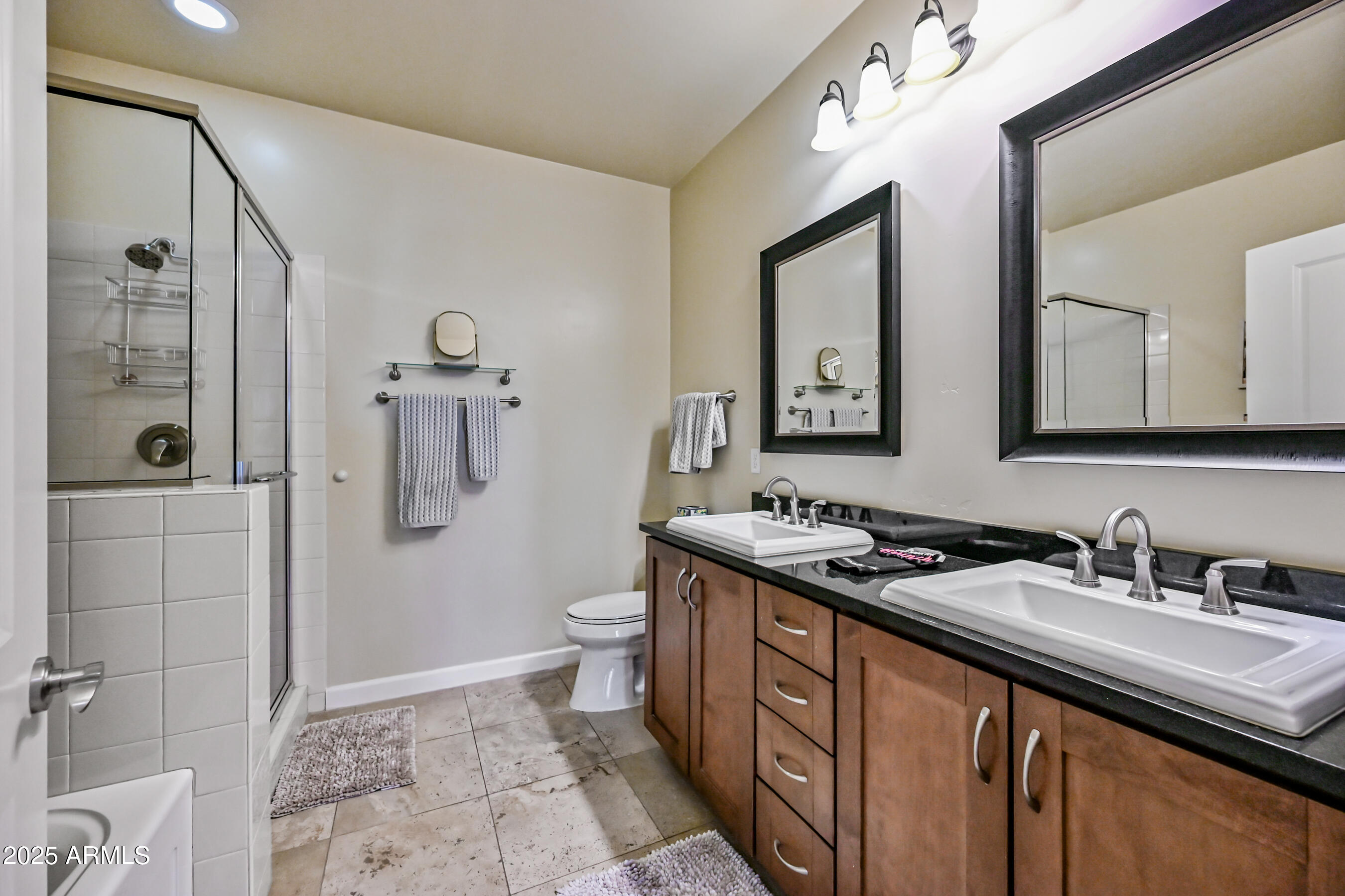 7291 North Scottsdale Road, Unit 2008 Paradise Valley, AZ 85253 - Photo 18 of 28 a bathroom with a sink a toilet a mirror and shower