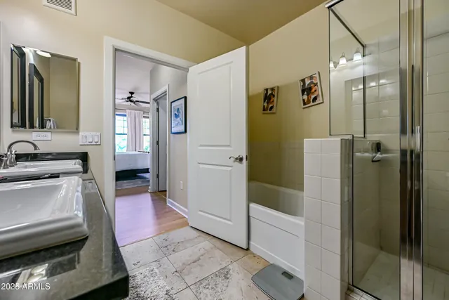 a bedroom with a large bed a flat tv screen and a dresser