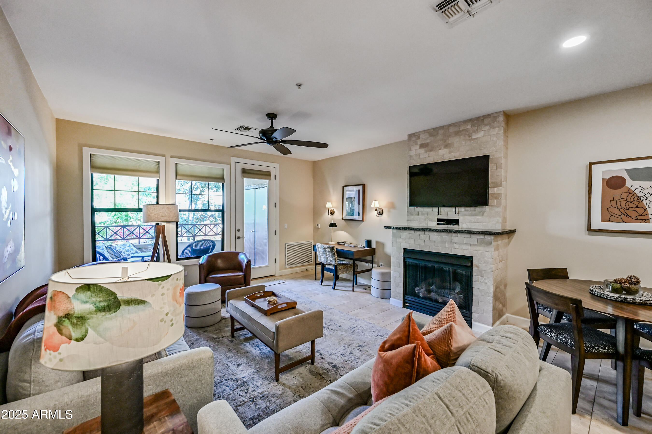7291 North Scottsdale Road, Unit 2008 Paradise Valley, AZ 85253 - Photo 5 of 28 a living room with furniture a fireplace and a flat screen tv