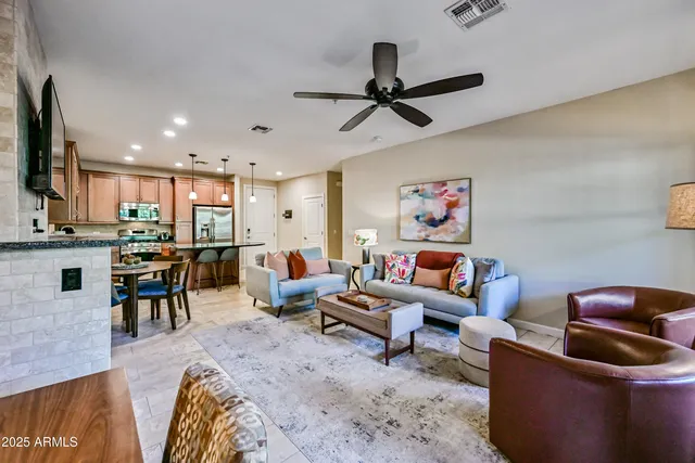 a living room with furniture a fireplace and a flat screen tv
