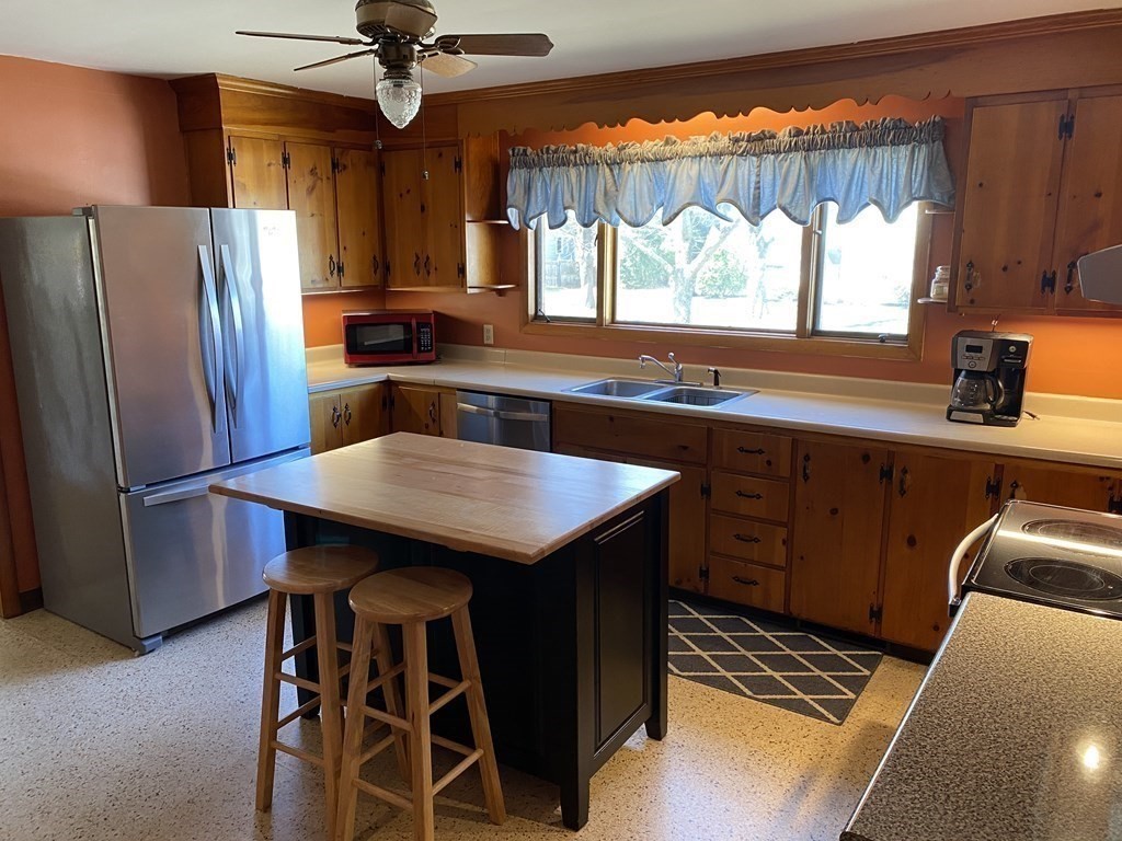 230 Straits Road Hatfield, MA 01038 - Photo 5 of 23 a kitchen with stainless steel appliances a table chairs and a refrigerator