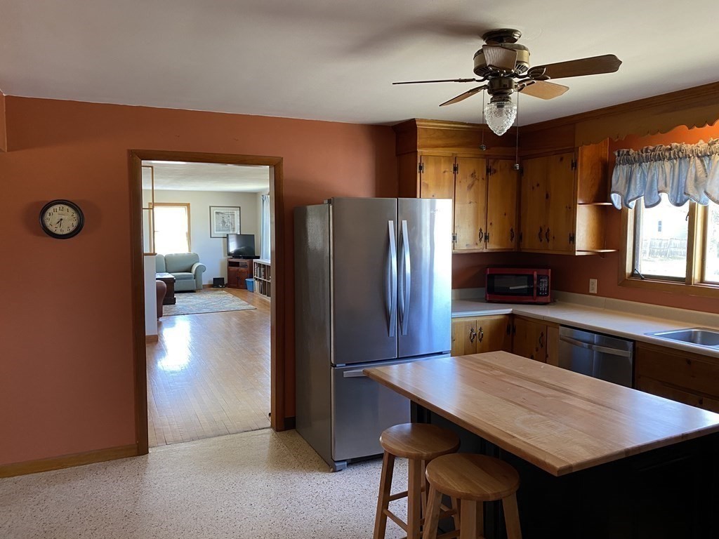 230 Straits Road Hatfield, MA 01038 - Photo 6 of 23 a kitchen with stainless steel appliances a table chairs and refrigerator