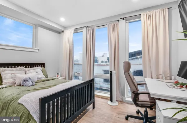 a bedroom with a bed and a large window