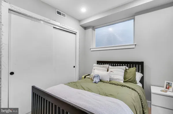 a bedroom with a bed and a window