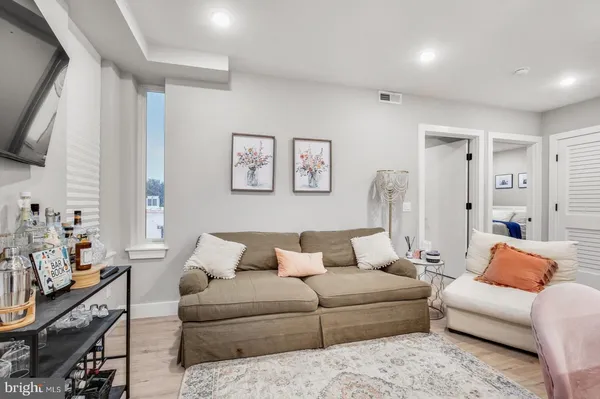 a bedroom with a large bed and a couch