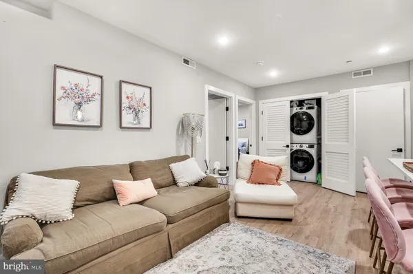 a living room with furniture and a glass door