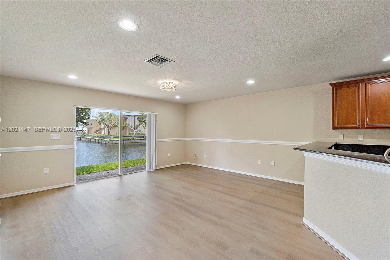 5930 Abbey Road Tamarac, FL 33321 - Photo 3 of 26 an empty room with wooden floor and window