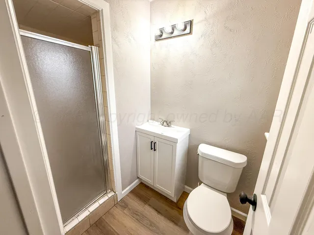 a white toilet sitting next to a bathroom sink