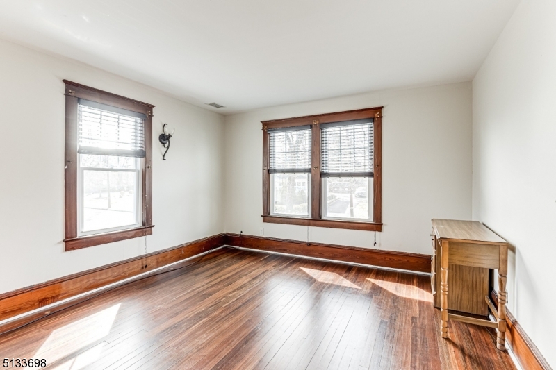 11 Village Road New Vernon, NJ 07976 - Photo 15 of 26 a view of an empty room with wooden floor and a window