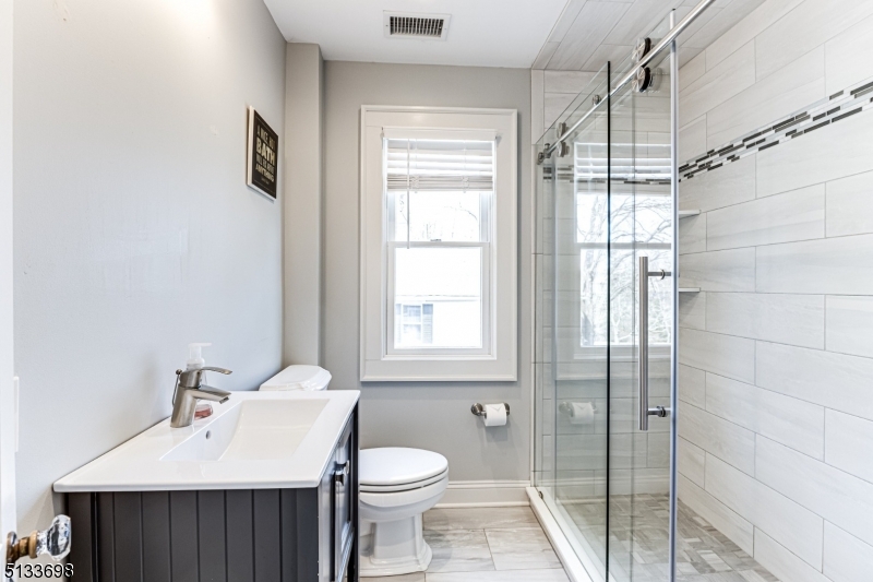 11 Village Road New Vernon, NJ 07976 - Photo 16 of 26 a bathroom with a sink toilet and shower