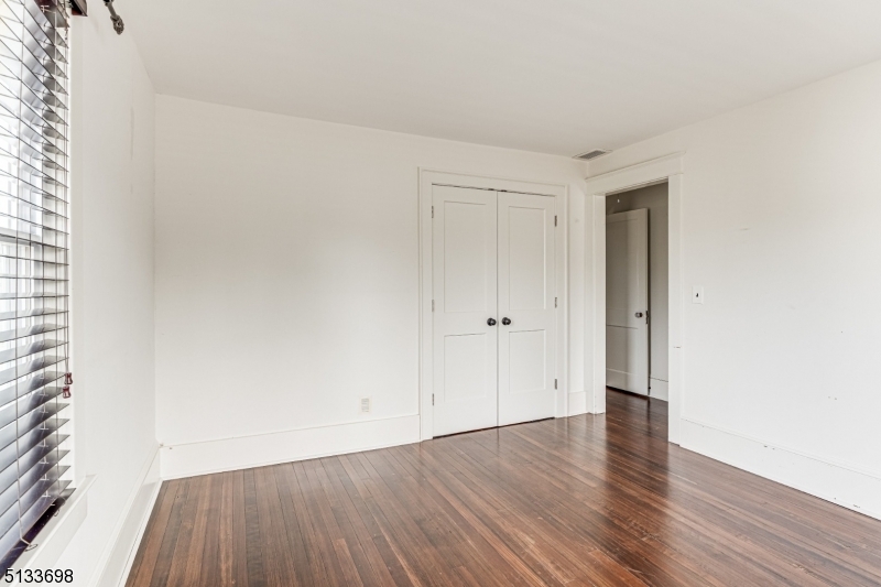 11 Village Road New Vernon, NJ 07976 - Photo 18 of 26 a view of an empty room and wooden floor