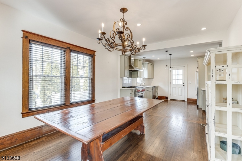 11 Village Road New Vernon, NJ 07976 - Photo 7 of 26 a dining room with wooden floor and chandelier