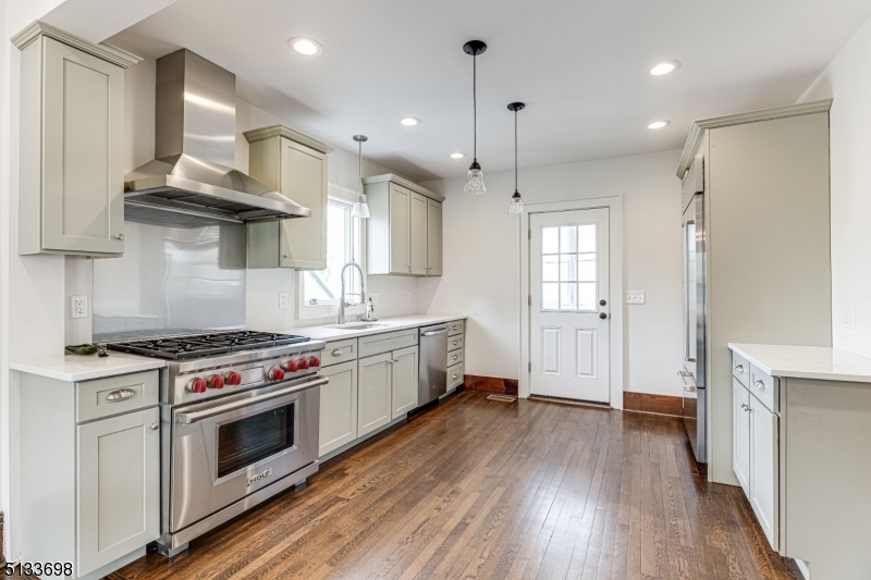 11 Village Road New Vernon, NJ 07976 - Photo 8 of 26 a kitchen with stainless steel appliances a stove a sink and wooden floor