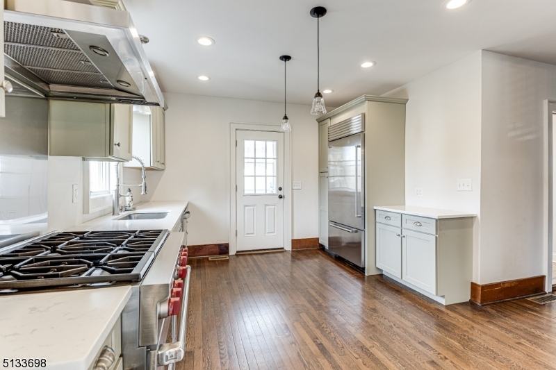 11 Village Road New Vernon, NJ 07976 - Photo 9 of 26 a kitchen with stove and white cabinets