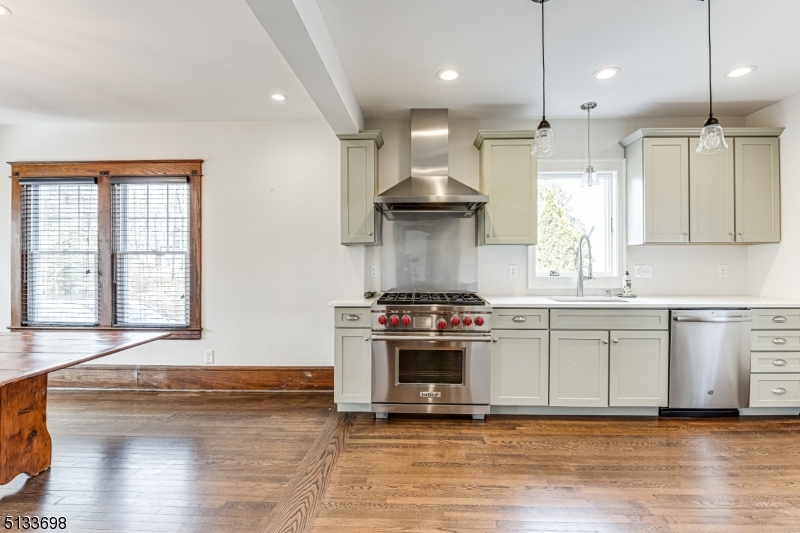 11 Village Road New Vernon, NJ 07976 - Photo 10 of 26 a large kitchen with stainless steel appliances granite countertop a stove a sink and a large refrigerator