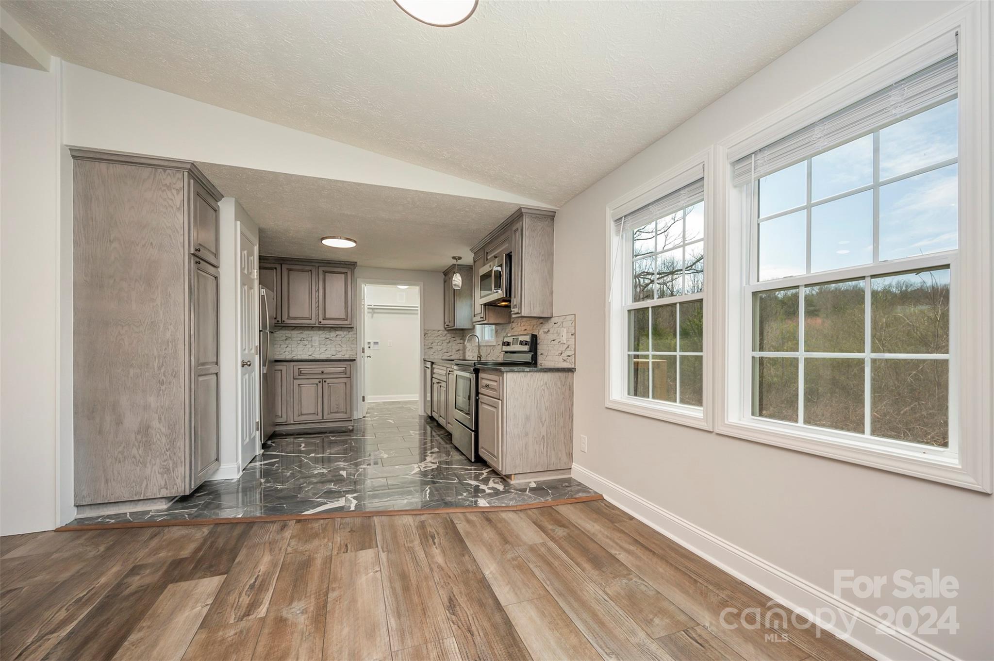 163 Mountain Creek Road Rutherfordton, NC 28139 - Photo 12 of 35 a view of a kitchen with wooden floor and a window