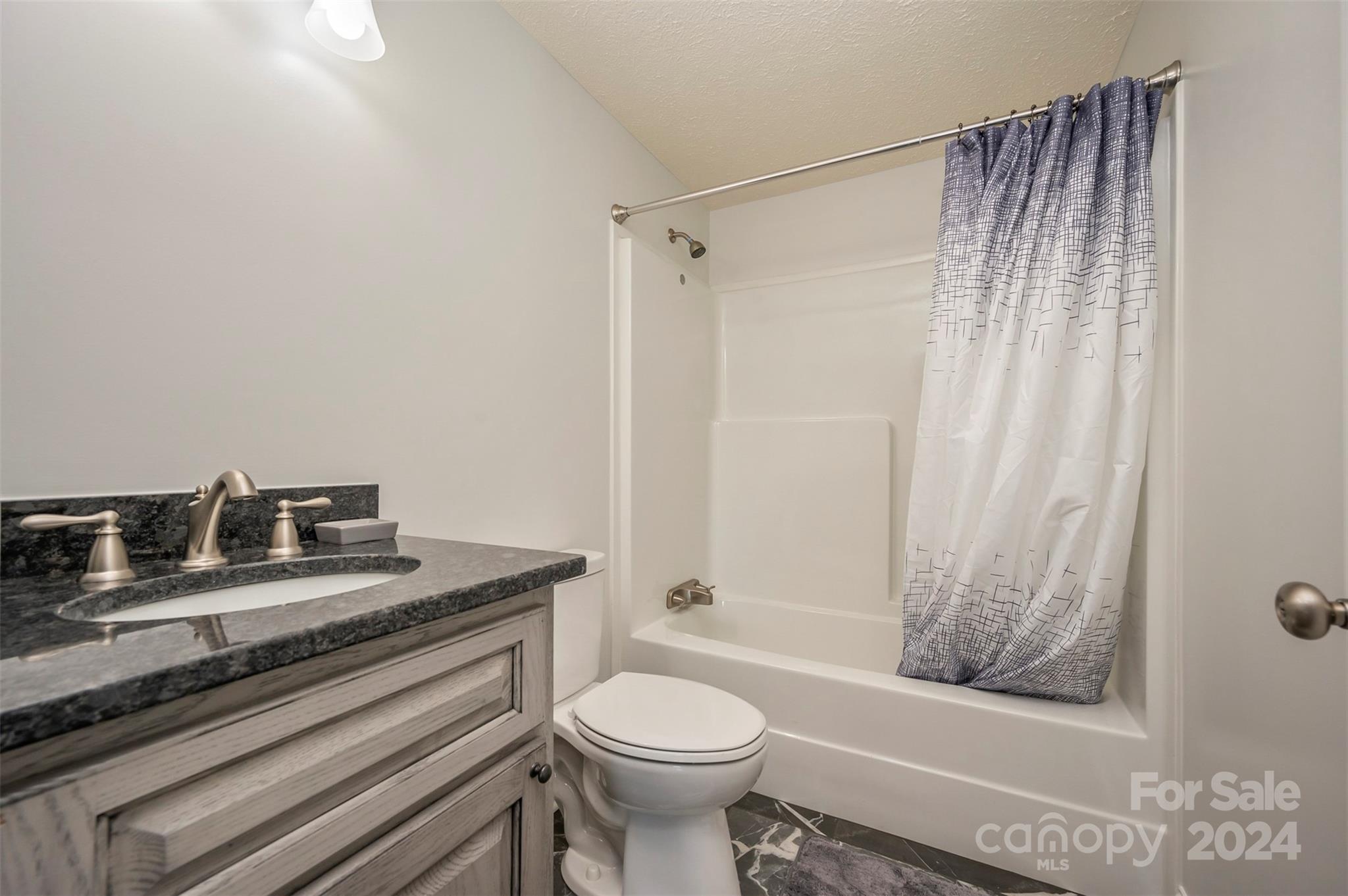 163 Mountain Creek Road Rutherfordton, NC 28139 - Photo 25 of 35 a bathroom with a granite countertop sink toilet and shower