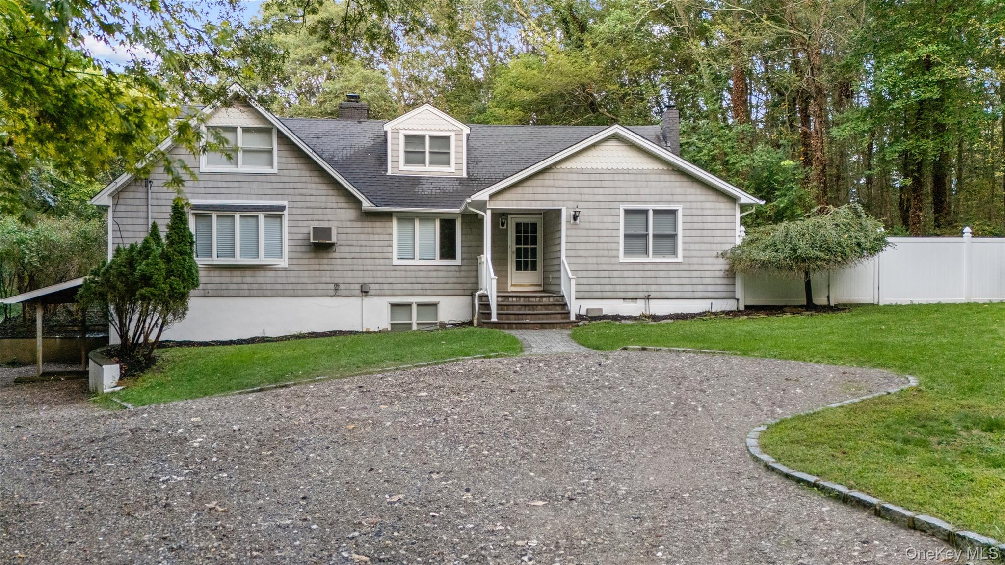 Back of house with a chimney, roof with shingles, a wall unit AC, and entry steps