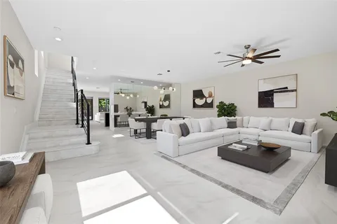 a living room with furniture ceiling fan and a rug