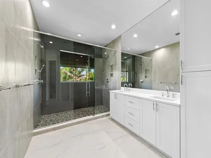 a bathroom with a shower sink and mirror