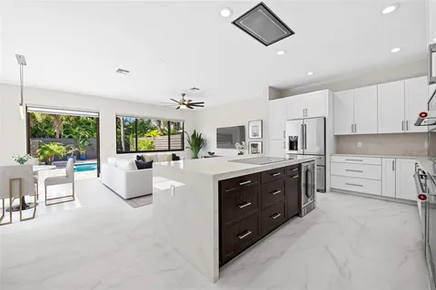 a spacious bathroom with a double vanity sink a large mirror and a bathtub