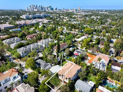 an aerial view of residential houses with city view