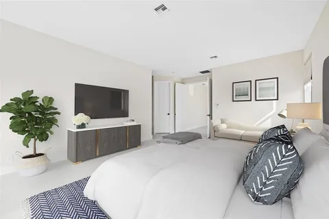 a bedroom with a bed and a television