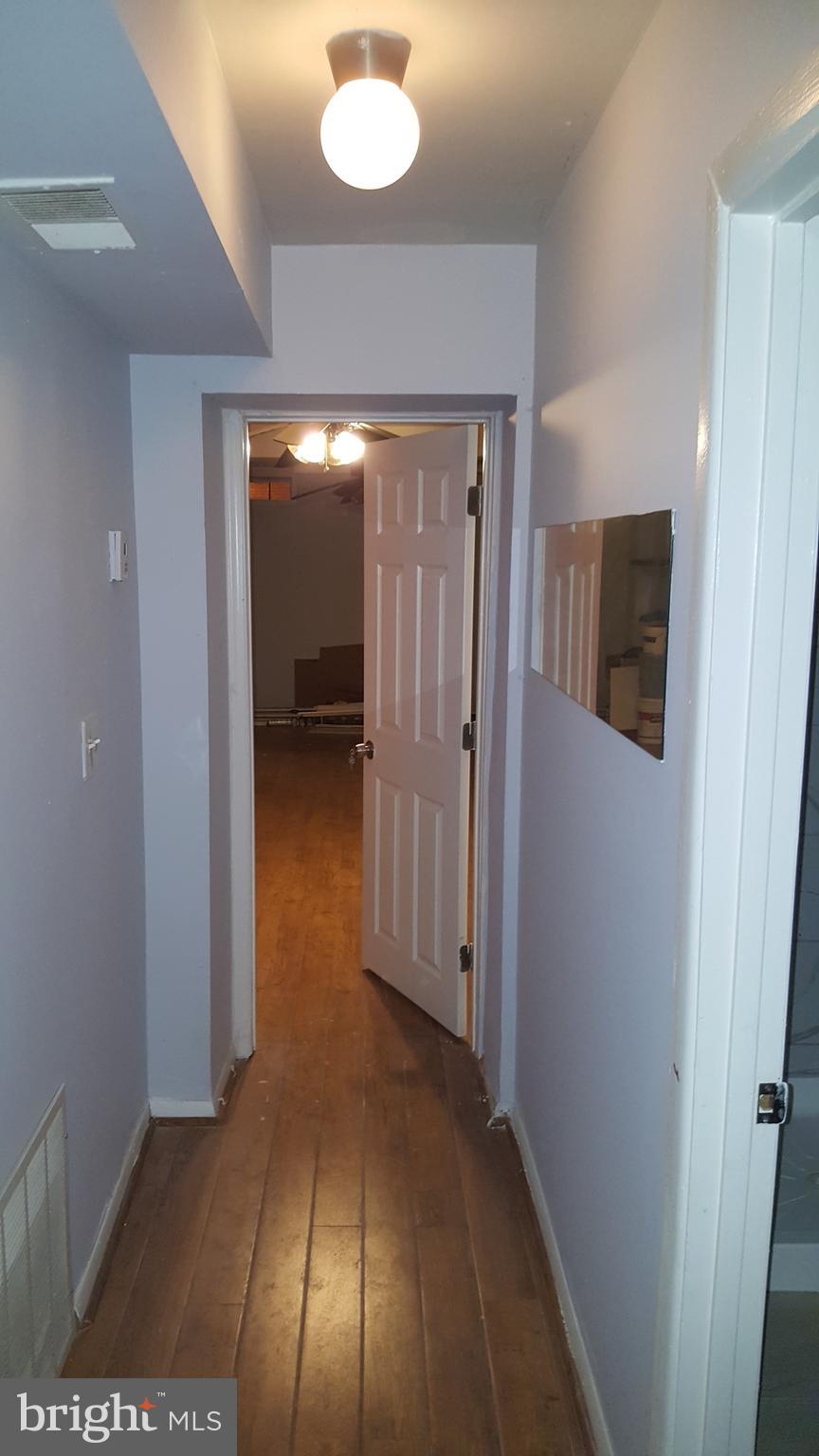 624 Stirling Street Baltimore, MD 21202 - Photo 20 of 27 a view of a hallway with wooden floor