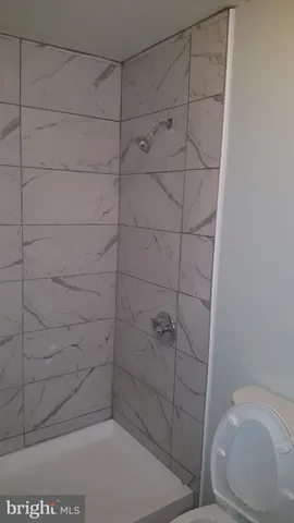 a bathroom with a sink toilet and a mirror