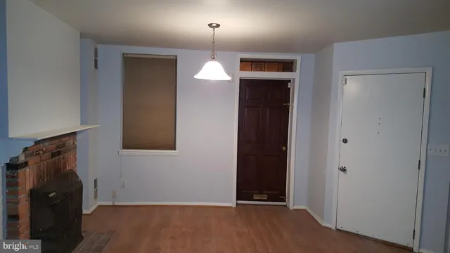 an empty room with a chandelier fan