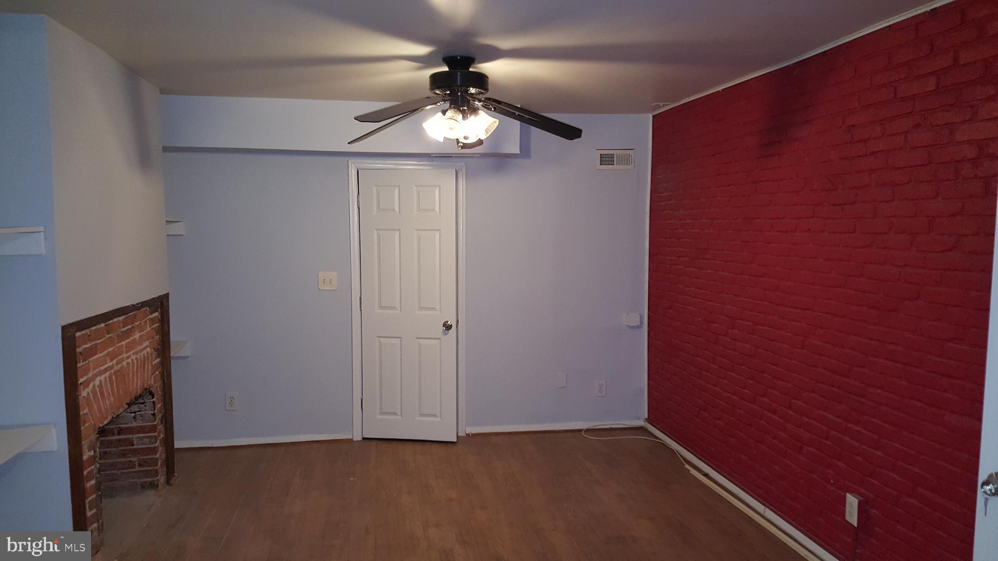 624 Stirling Street Baltimore, MD 21202 - Photo 27 of 27 an empty room with a chandelier fan