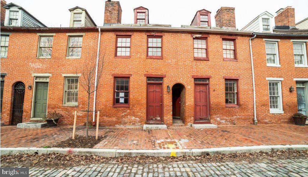 624 Stirling Street Baltimore, MD 21202 - Photo 3 of 27 a view of a brick house with many windows