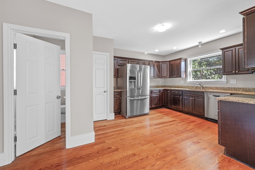 21 Lyman Street Beverly, MA 01915 - Photo 12 of 33 a kitchen with stainless steel appliances granite countertop a refrigerator and a sink