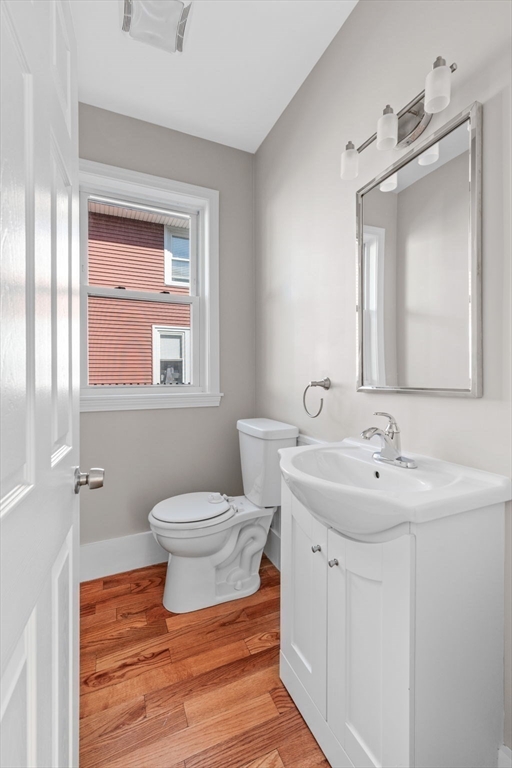 21 Lyman Street Beverly, MA 01915 - Photo 13 of 33 a bathroom with a toilet a sink and mirror