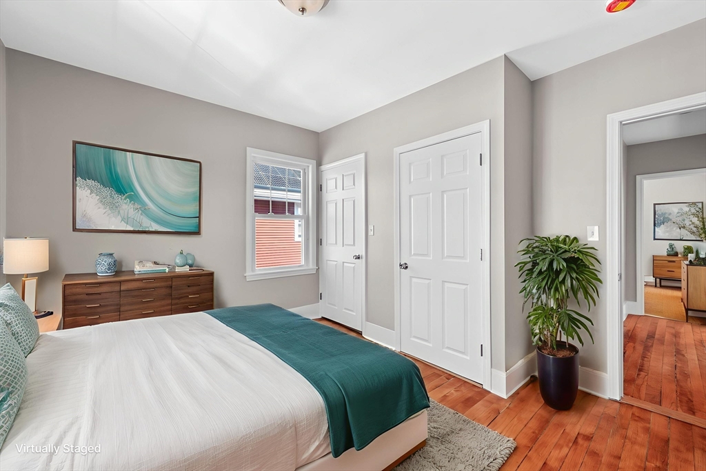 21 Lyman Street Beverly, MA 01915 - Photo 15 of 33 a bedroom with a bed and a potted plant