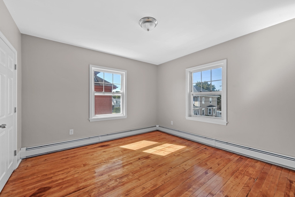 21 Lyman Street Beverly, MA 01915 - Photo 16 of 33 a view of empty room with wooden floor and fan