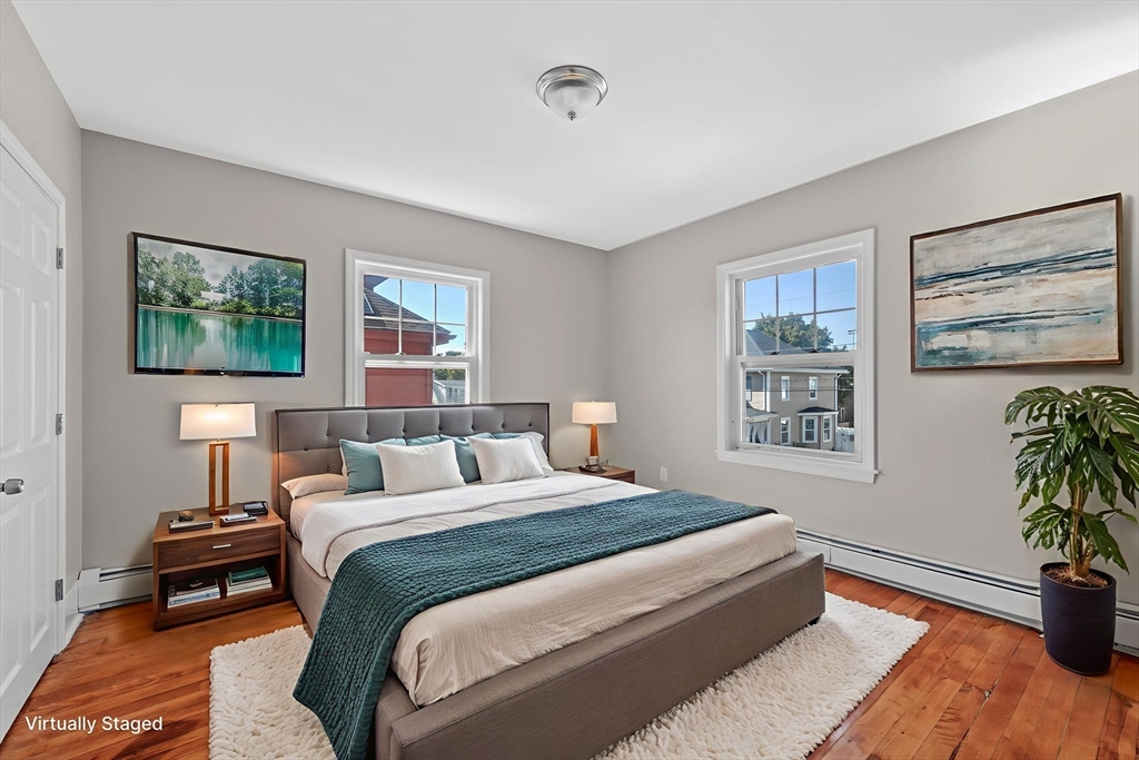 21 Lyman Street Beverly, MA 01915 - Photo 17 of 33 a bedroom with a bed and a painting on the wall