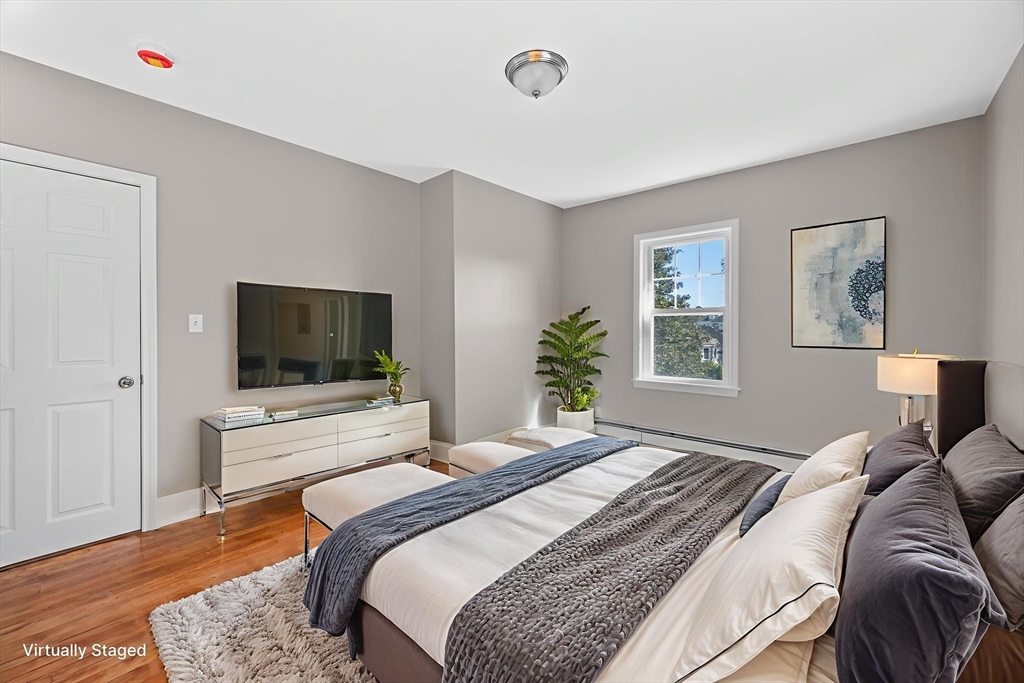 21 Lyman Street Beverly, MA 01915 - Photo 19 of 33 a bedroom with a bed and a flat screen tv