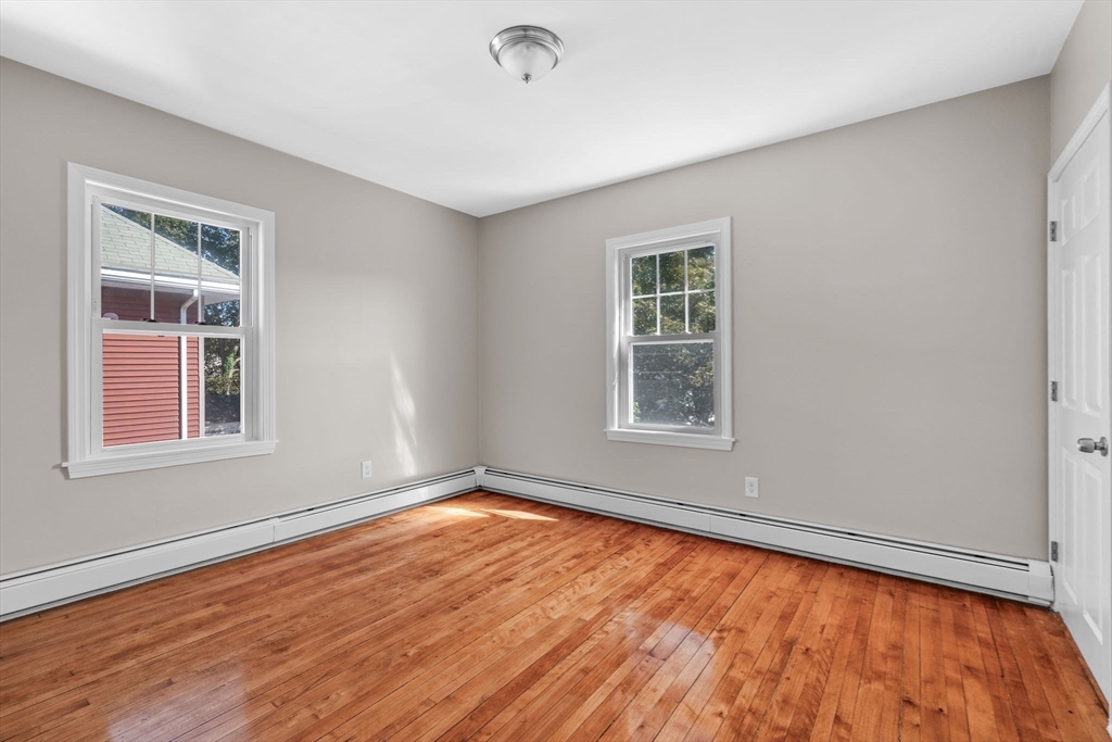 21 Lyman Street Beverly, MA 01915 - Photo 20 of 33 a view of an empty room with wooden floor and a window