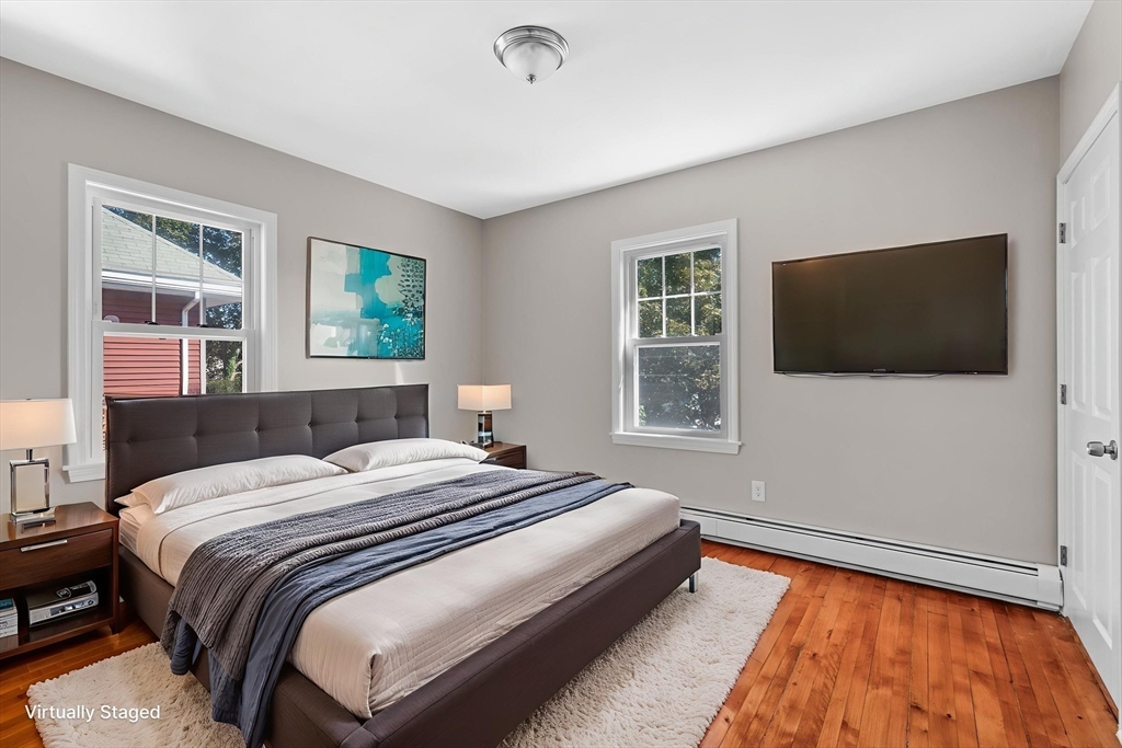 21 Lyman Street Beverly, MA 01915 - Photo 21 of 33 a bedroom with a bed television on desk and a window