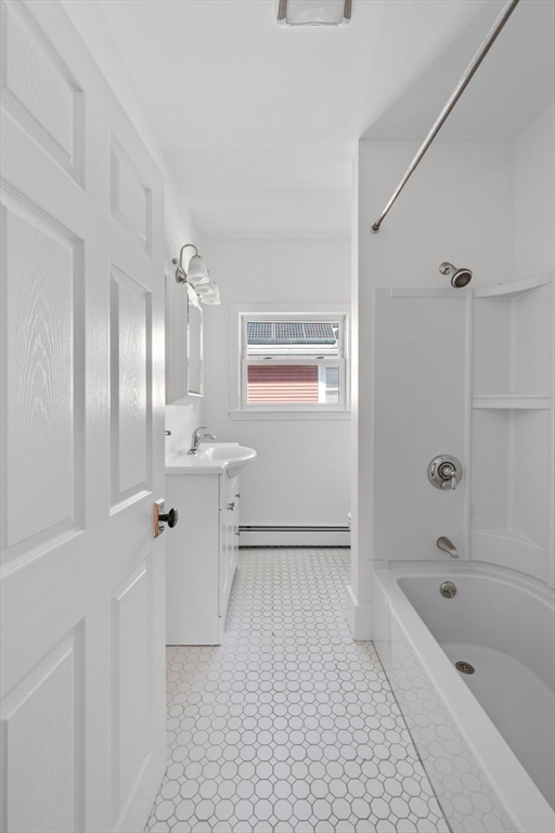 21 Lyman Street Beverly, MA 01915 - Photo 22 of 33 a bathroom with a sink a toilet and shower