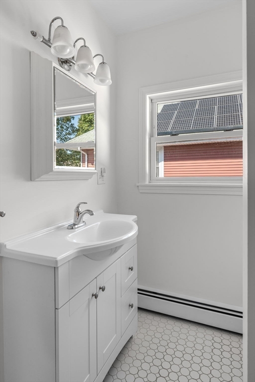 21 Lyman Street Beverly, MA 01915 - Photo 23 of 33 a bathroom with a sink and a mirror
