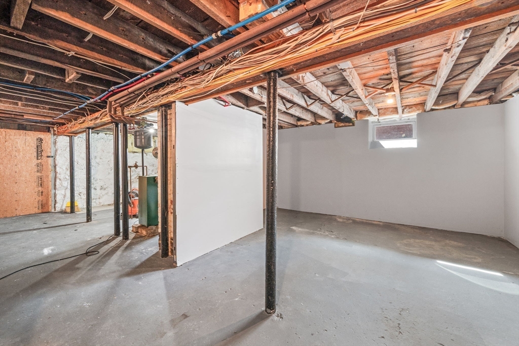21 Lyman Street Beverly, MA 01915 - Photo 24 of 33 a view of a room with wooden walls and stairs