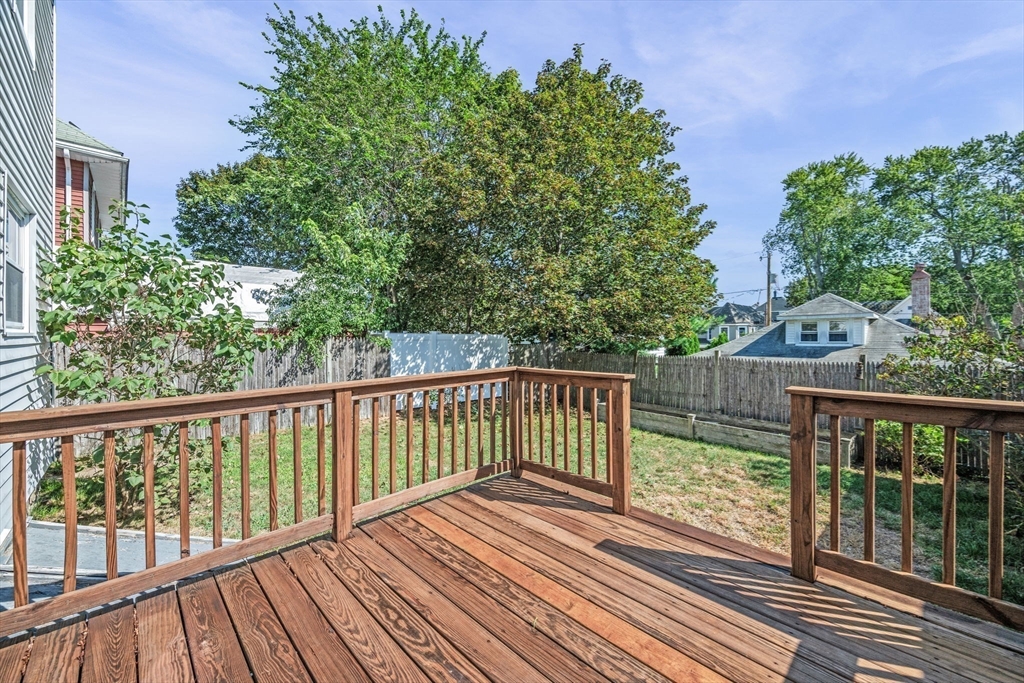 21 Lyman Street Beverly, MA 01915 - Photo 26 of 33 a view of balcony with wooden floor and fence